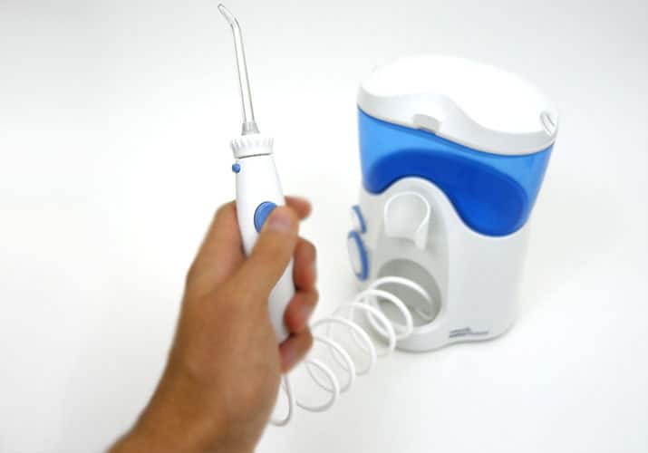 Waterpik Ultra Want held in left hand being tested