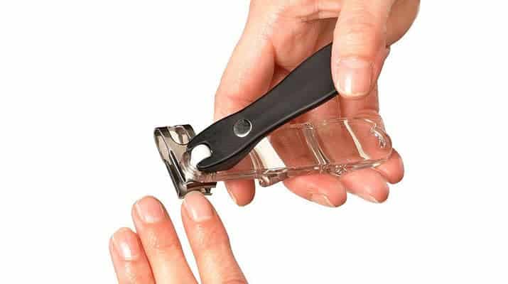 Fingernails being cut by swivel nail clippers with rotating blades