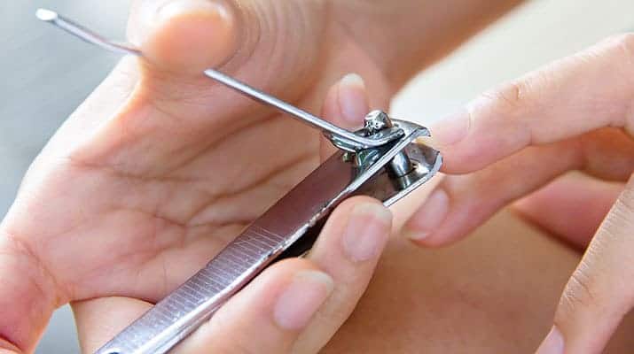 Cutting fingernails with large nail clippers